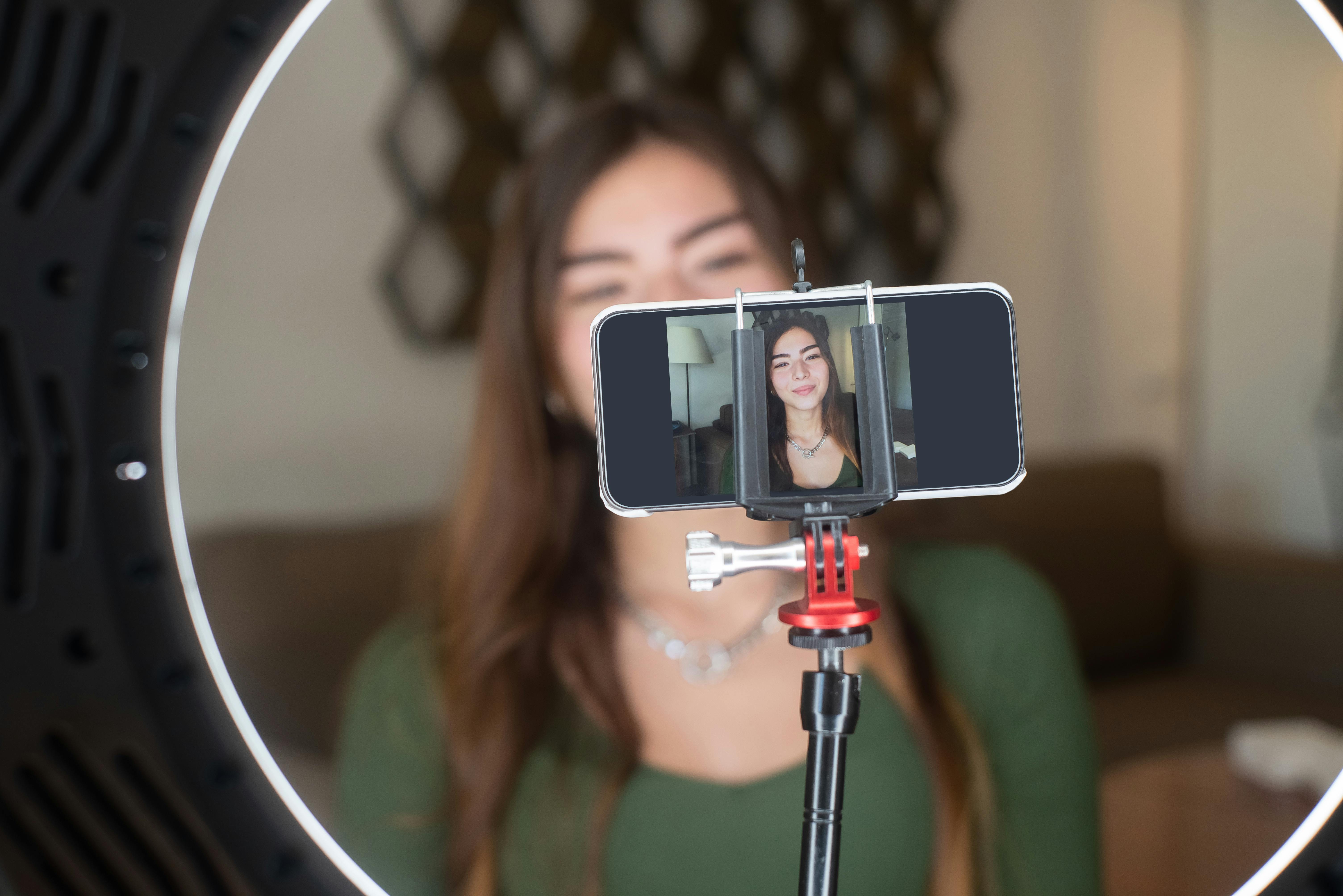 A woman in a phone getting ready to live stream content for her Instagram stories